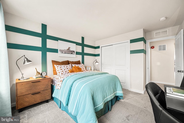 bedroom featuring light colored carpet and a closet