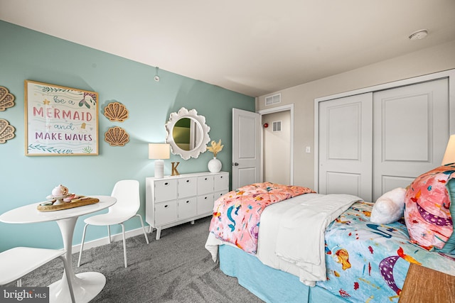 bedroom with a closet and dark colored carpet