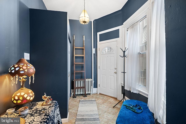 entryway with radiator heating unit and light tile patterned floors