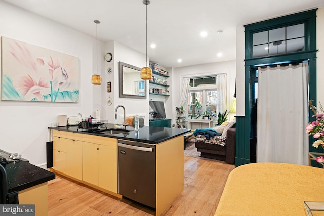 kitchen featuring sink, decorative light fixtures, dishwasher, and light wood-type flooring