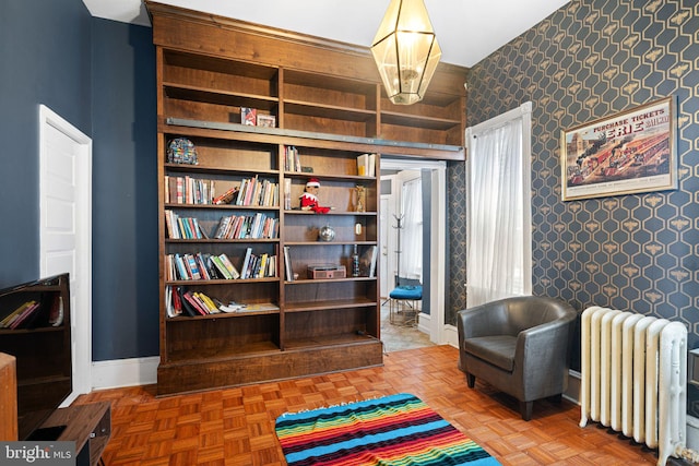 living area with radiator heating unit and parquet flooring