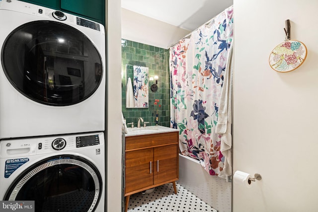 clothes washing area featuring stacked washer / drying machine and sink