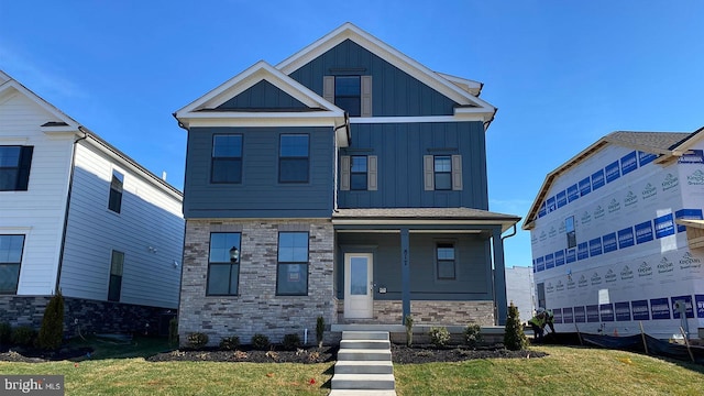 view of front of house featuring a front yard and covered porch