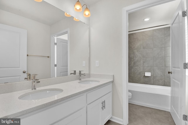 full bathroom with vanity, toilet, tiled shower / bath combo, and tile patterned flooring