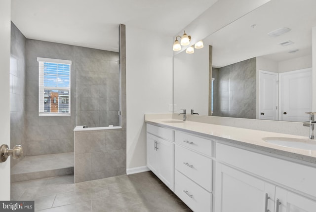 bathroom featuring vanity, tile patterned flooring, and a shower