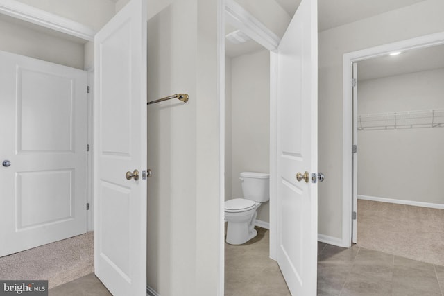 bathroom with tile patterned floors and toilet