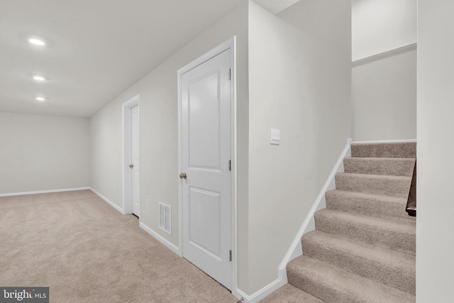 staircase featuring carpet flooring