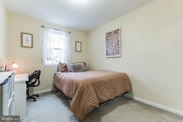 bedroom with light colored carpet