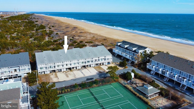 drone / aerial view with a water view and a view of the beach