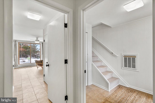 stairway with ornamental molding, tile patterned floors, and ceiling fan