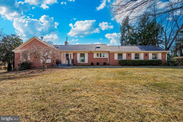 ranch-style home with a front yard and brick siding