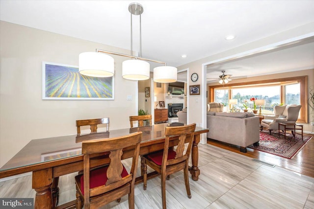 dining room featuring ceiling fan, light wood-style floors, visible vents, and recessed lighting