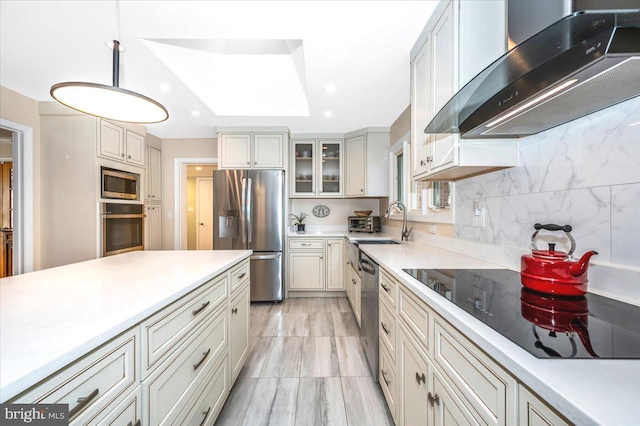 kitchen with light countertops, ventilation hood, appliances with stainless steel finishes, tasteful backsplash, and glass insert cabinets