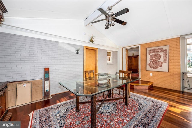 office area featuring ceiling fan, lofted ceiling with beams, brick wall, and wood finished floors