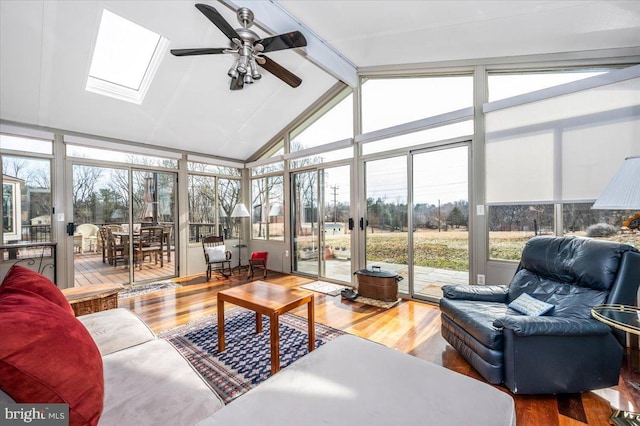 sunroom / solarium with vaulted ceiling with skylight