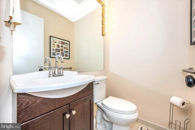 half bath featuring toilet and vanity