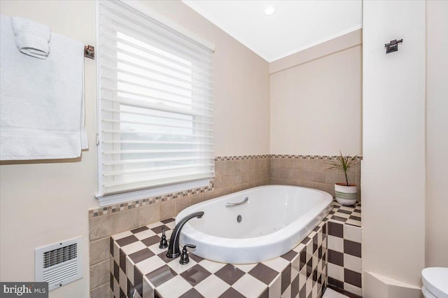 full bathroom featuring ornamental molding, a tub with jets, and visible vents