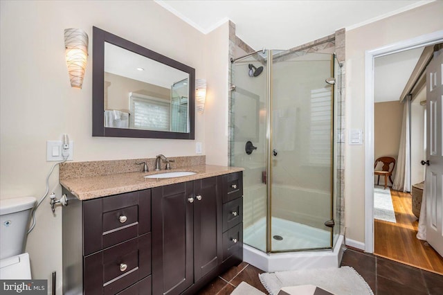 full bathroom featuring a stall shower, vanity, ornamental molding, and tile patterned floors