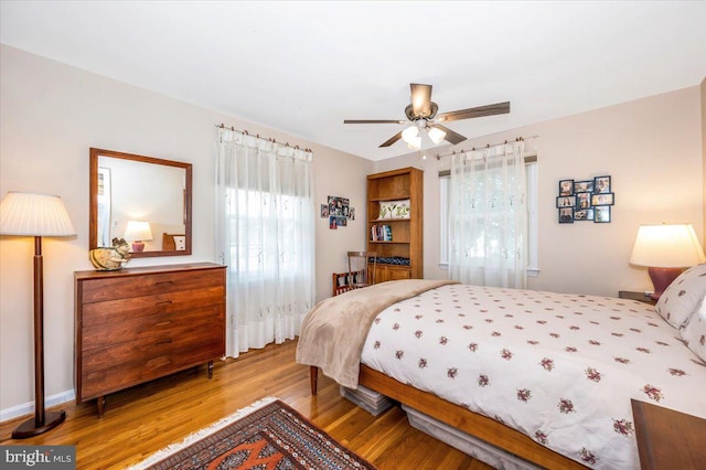 bedroom with a ceiling fan and wood finished floors