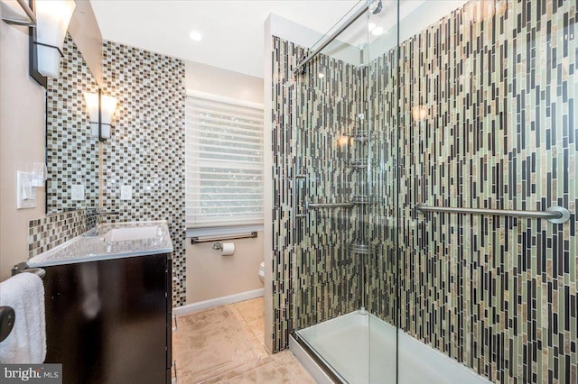 bathroom with vanity, tile patterned flooring, a shower stall, and toilet