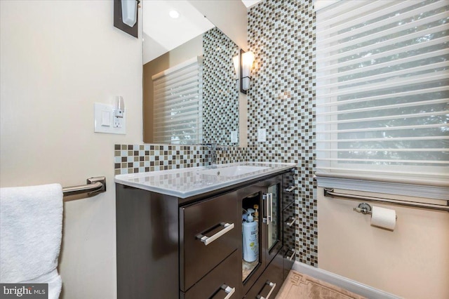 bathroom featuring a sink and backsplash