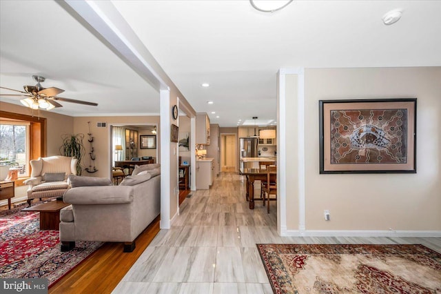 living area featuring ceiling fan, recessed lighting, visible vents, and baseboards