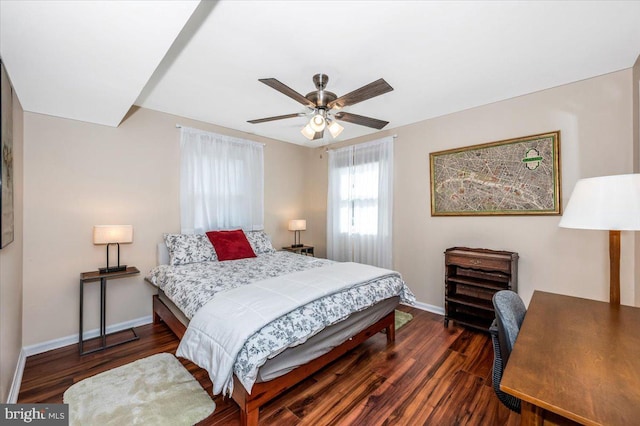 bedroom with a ceiling fan, baseboards, and wood finished floors