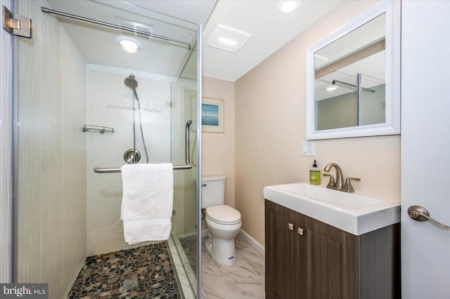 bathroom featuring toilet, vanity, baseboards, marble finish floor, and a stall shower