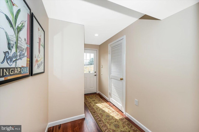 corridor featuring wood finished floors and baseboards