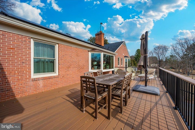 wooden terrace with outdoor dining area