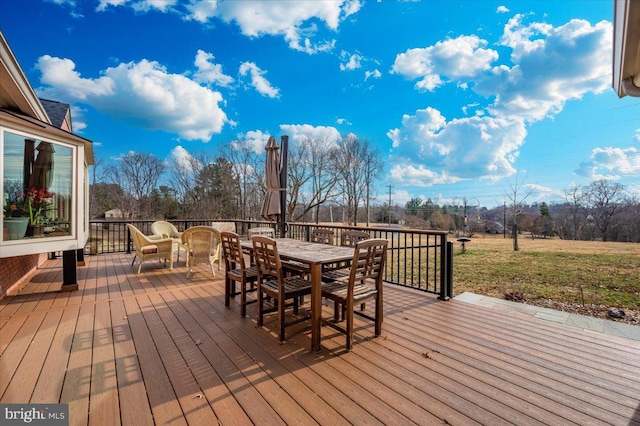 wooden deck featuring outdoor dining area