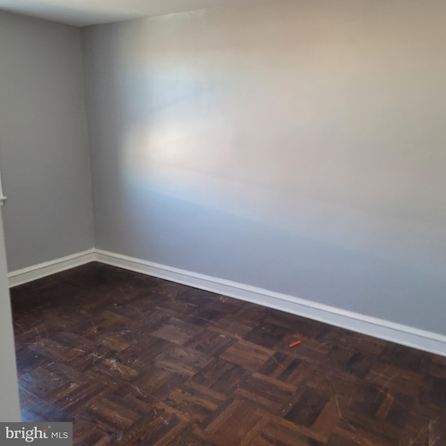 empty room with dark parquet flooring