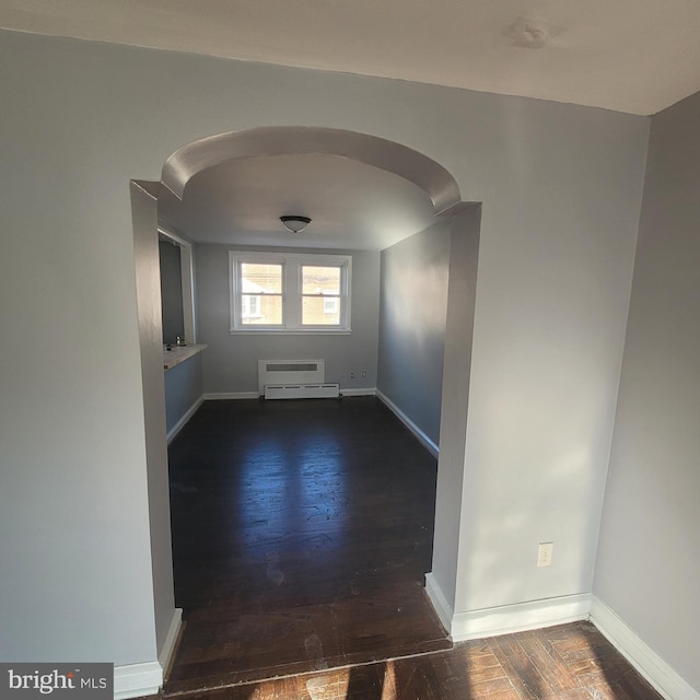 empty room with dark hardwood / wood-style flooring