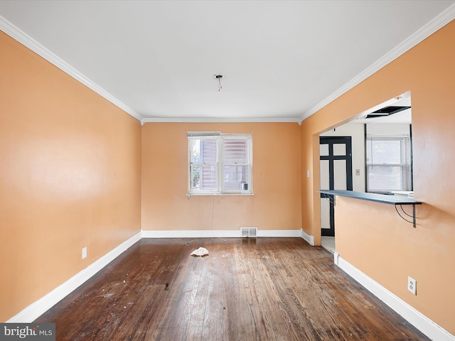 empty room with dark wood-type flooring, ornamental molding, and plenty of natural light