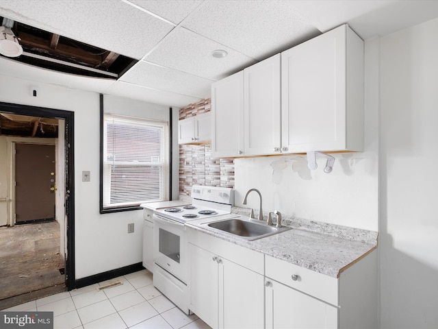 kitchen with white cabinetry, backsplash, sink, and electric range