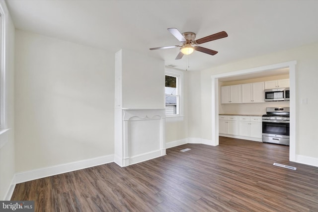 unfurnished living room featuring dark hardwood / wood-style floors and ceiling fan