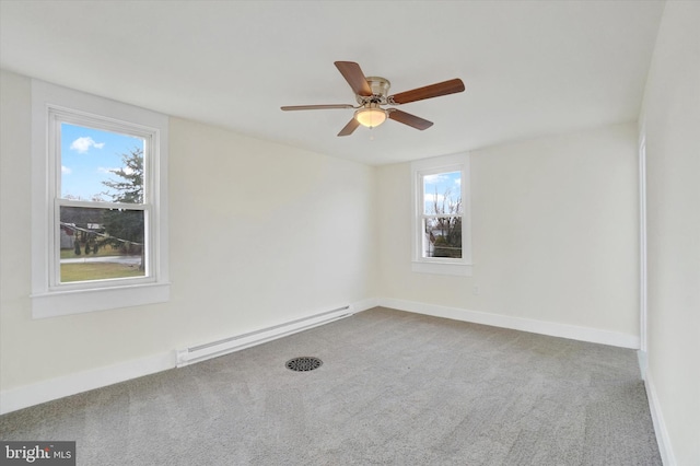 empty room featuring a baseboard heating unit, ceiling fan, and carpet flooring