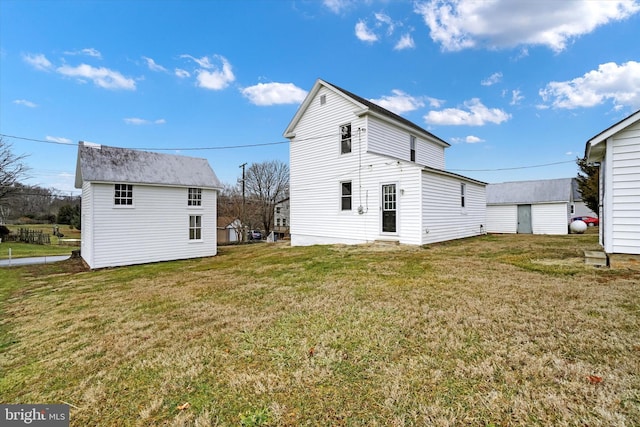 rear view of house with a storage shed and a yard