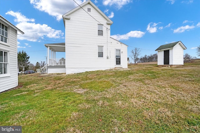 back of property with a shed and a lawn