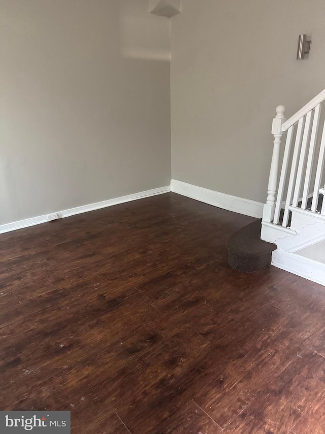 spare room with dark wood-type flooring