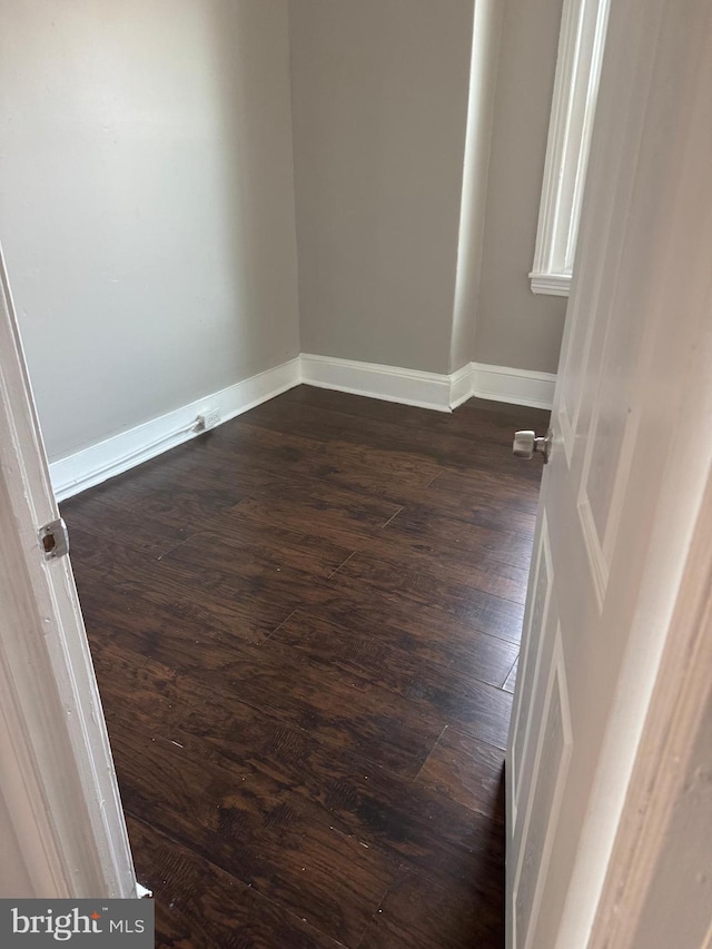 empty room featuring dark hardwood / wood-style flooring