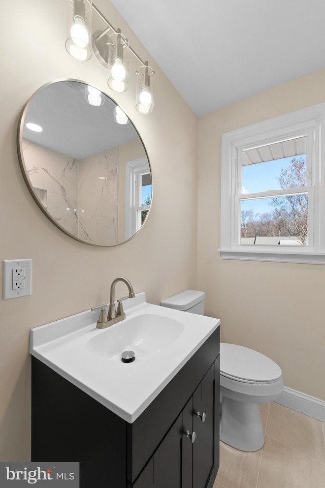 bathroom with vanity, toilet, and tile patterned flooring