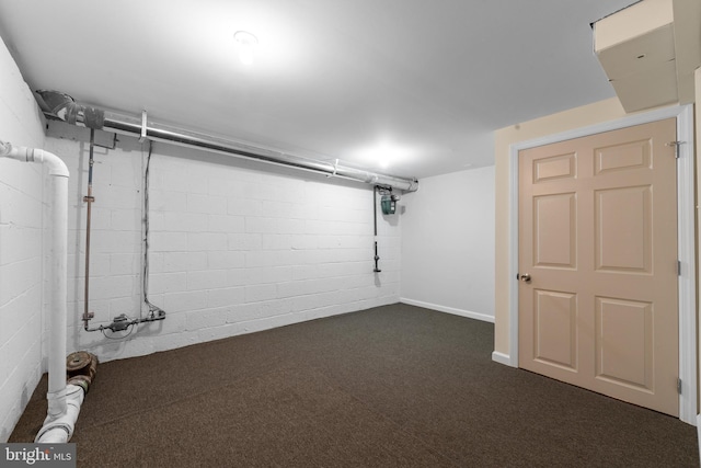 basement featuring dark carpet