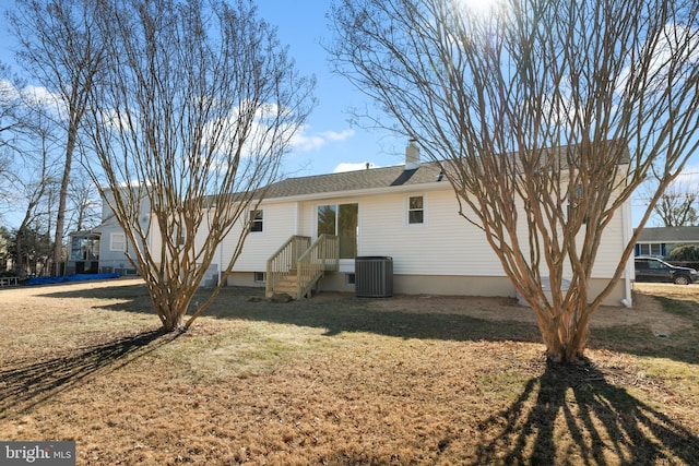 back of house with a yard and central air condition unit