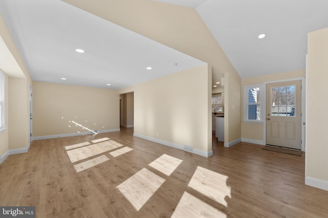 entryway featuring vaulted ceiling and light hardwood / wood-style floors