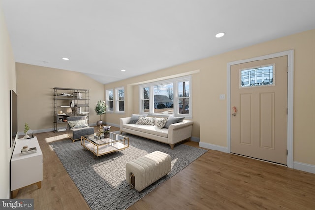 living room featuring hardwood / wood-style flooring and lofted ceiling