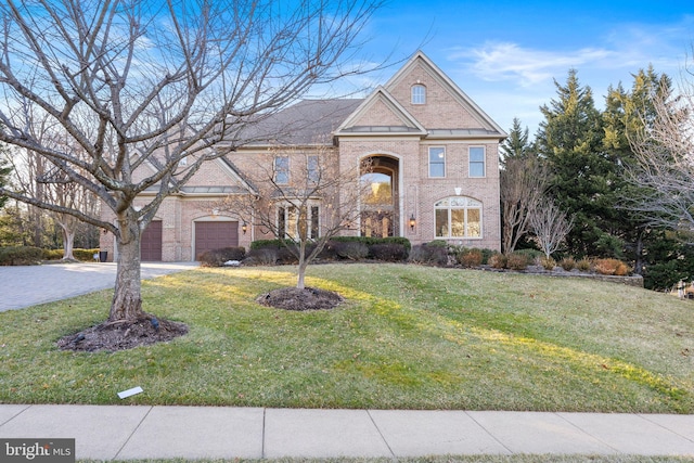 view of front facade with a front lawn and a garage