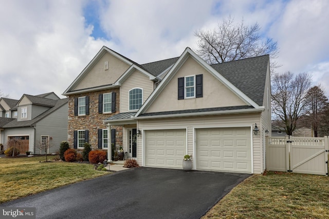 view of front of house with a garage and a front lawn