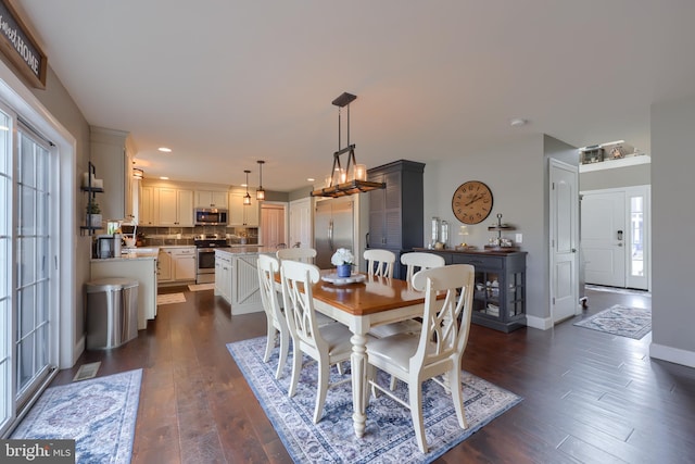 dining space with dark wood-type flooring