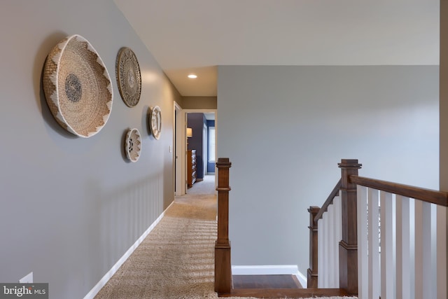 hall featuring carpet flooring